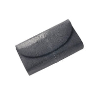 Black textured clutch bag on a white background