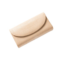 Beige textured clutch bag on a white background