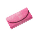 Pink clutch bag with a textured surface on a white background