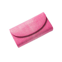Pink clutch bag with a textured surface on a white background