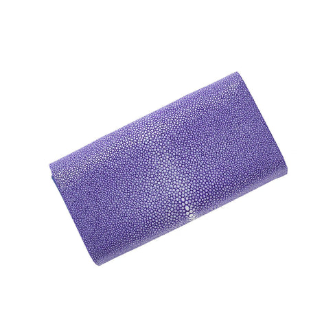 Purple clutch bag with a textured surface on a white background