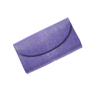 Purple studded clutch bag on a white background